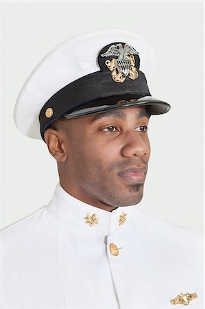 Young, African American military officer, studio shot on gray background Stock Photo - Premium Royalty-Free, Code: 693-06379097