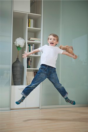 screaming human yelling - Portrait of a boy in casuals jumping in mid-air Stock Photo - Premium Royalty-Free, Code: 693-06379445