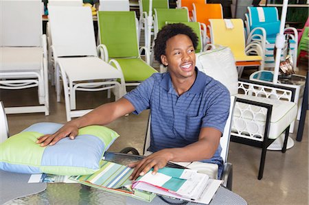 seating furniture - Male African American salesperson working in garden furniture store Stock Photo - Premium Royalty-Free, Code: 693-06379611