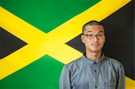 Portrait of a man with raised eyebrows against Jamaican flag Stock Photo - Premium Royalty-Free, Code: 693-06379640