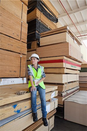 simsearch:693-06379747,k - Female industrial worker having coffee while sitting on stack of wooden planks Stock Photo - Premium Royalty-Free, Code: 693-06379681