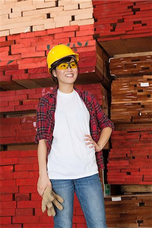 simsearch:693-06379747,k - Asian female industrial worker looking away with stacked wooden planks in background Stock Photo - Premium Royalty-Free, Code: 693-06379730