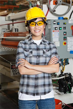 simsearch:693-06379747,k - Portrait of happy Asian female industrial worker with machinery in background Stock Photo - Premium Royalty-Free, Code: 693-06379756