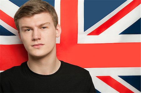 symbol for intelligence - Portrait of young man against British flag Stock Photo - Premium Royalty-Free, Code: 693-06379930
