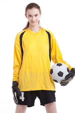 soccer player holding ball - Portrait of young female soccer player with ball against white background Stock Photo - Premium Royalty-Free, Code: 693-06403245