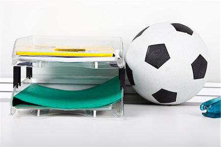 Soccer ball near file rack at desk Stock Photo - Premium Royalty-Free, Code: 693-06403386