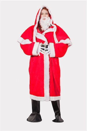 simsearch:693-06435898,k - Portrait of young woman in Santa costume standing against gray background Stock Photo - Premium Royalty-Free, Code: 693-06435894