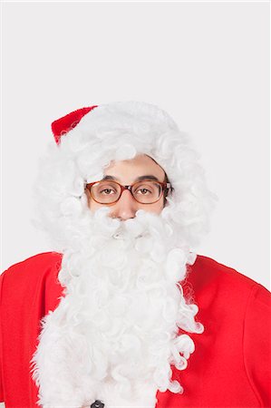 simsearch:693-06435898,k - Portrait of man in Santa costume against gray background Stock Photo - Premium Royalty-Free, Code: 693-06435900