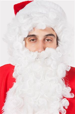 simsearch:693-06435898,k - Portrait of young man in Santa costume against gray background Stock Photo - Premium Royalty-Free, Code: 693-06435901