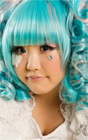 Close-up portrait of young woman with blue hair dressed as a doll Stock Photo - Premium Royalty-Free, Code: 693-06436074