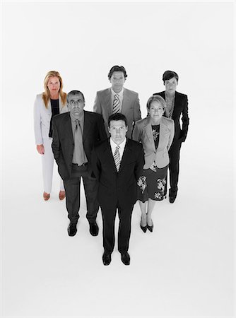 Ambitious businessman with team of professionals against white background Stock Photo - Premium Royalty-Free, Code: 693-06668052