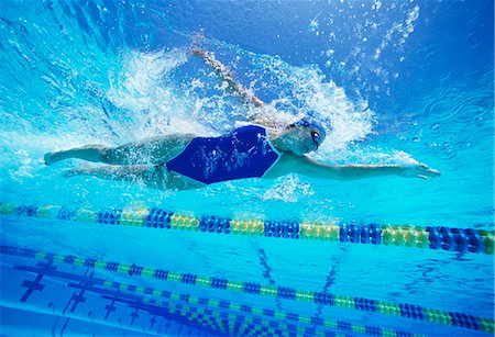 swimming pool photos - Female swimmer wearing United States swimsuit while swimming in pool Stock Photo - Premium Royalty-Free, Code: 693-06668082