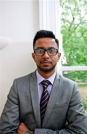 suit man eyeglasses - Portrait of Indian Businessman wearing glasses with hands folded Stock Photo - Premium Royalty-Free, Code: 693-06967506