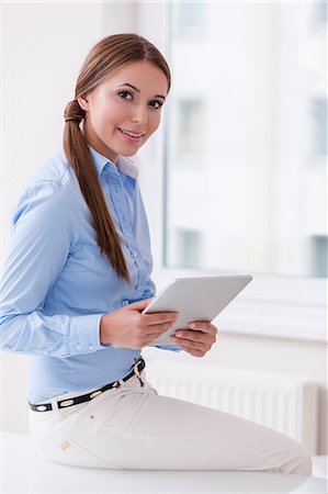 Beautiful businesswoman using tablet computer Stock Photo - Premium Royalty-Free, Code: 693-07444408