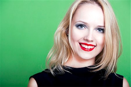 red lips - Sexy blonde woman on green background Stock Photo - Premium Royalty-Free, Code: 693-07444531