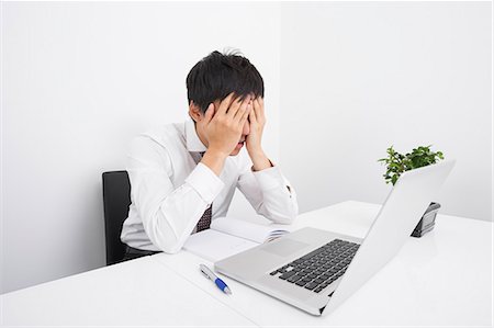 frustrated - Tired businessman with laptop on desk in office Stock Photo - Premium Royalty-Free, Code: 693-07455896