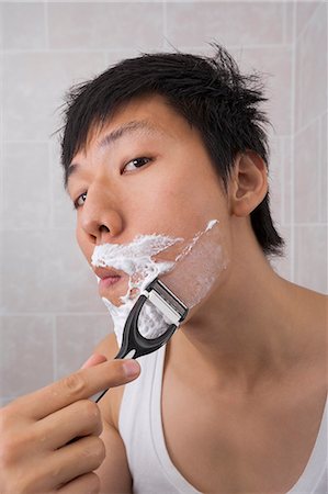 razor - Portrait of mid adult Asian man shaving in bathroom Stock Photo - Premium Royalty-Free, Code: 693-07455936