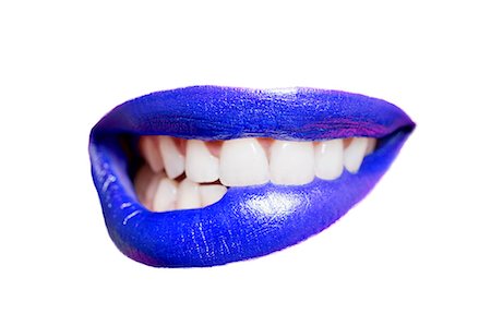 Close-up of teeth biting blue lip over white background Stock Photo - Premium Royalty-Free, Code: 693-07456327