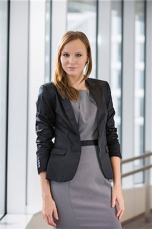 Portrait of beautiful businesswoman standing in office Stock Photo - Premium Royalty-Free, Code: 693-07542124