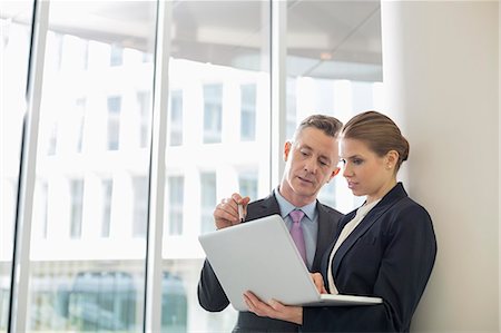 focused professional - Business colleagues using laptop in office Stock Photo - Premium Royalty-Free, Code: 693-07542143