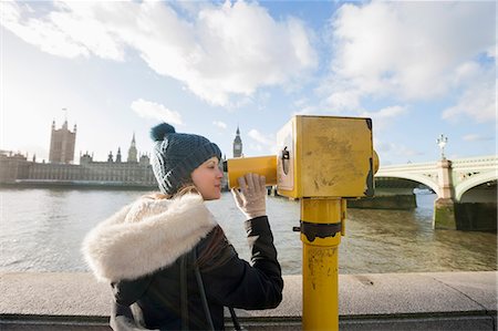 Side view of young woman looking through telescope by river Thames, London, UK Stock Photo - Premium Royalty-Free, Code: 693-07542369