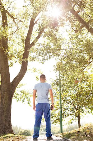 simsearch:693-07672615,k - Full length rear view of fit man standing on path in park Stock Photo - Premium Royalty-Free, Code: 693-07672606