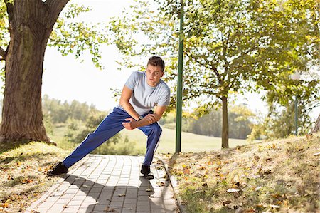 simsearch:693-07672615,k - Full length of young man stretching on path in park Stock Photo - Premium Royalty-Free, Code: 693-07672607