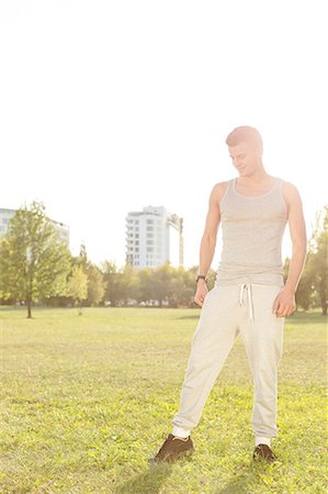 simsearch:693-07672615,k - Full length of fit man standing in park Stock Photo - Premium Royalty-Free, Code: 693-07672611