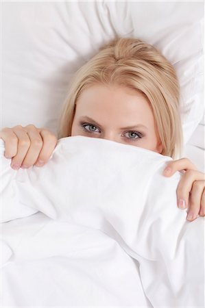 resting on the bed - Portrait of young woman covering face with bed sheet Stock Photo - Premium Royalty-Free, Code: 693-07672699
