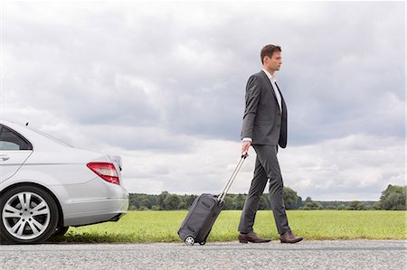 simsearch:693-07672717,k - Full length side view of young businessman with suitcase leaving broken down car at countryside Stock Photo - Premium Royalty-Free, Code: 693-07672838