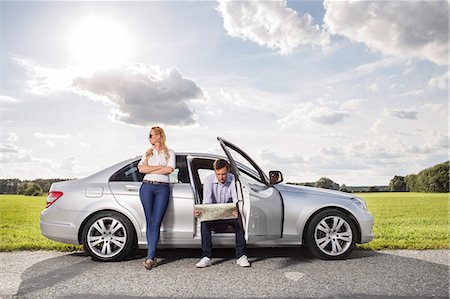 road map - Full length of young woman looking away while man reading map in car at countryside Stock Photo - Premium Royalty-Free, Code: 693-07672857