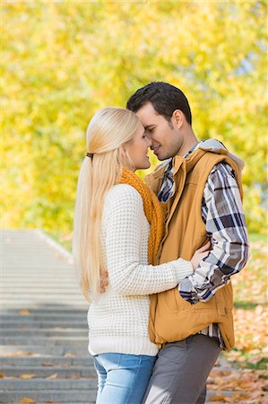 Couple kissing in park during autumn Stock Photo - Premium Royalty-Free, Code: 693-07672895