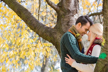 simsearch:693-07672684,k - Side view of young couple hugging near autumn tree in park Stock Photo - Premium Royalty-Free, Code: 693-07672907