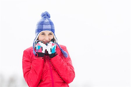 Beautiful young woman in warm clothing walking outdoors Stock Photo - Premium Royalty-Free, Code: 693-07673113