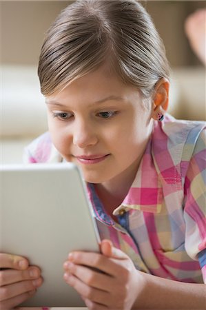 simsearch:693-07542313,k - Close-up of girl using digital tablet at home Stock Photo - Premium Royalty-Free, Code: 693-07673248