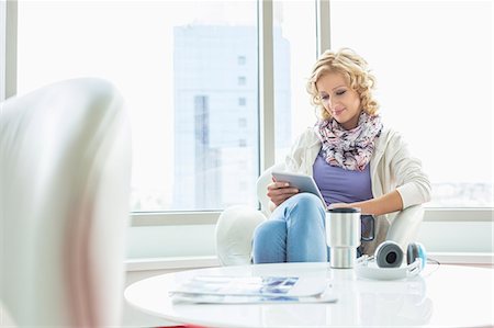 simsearch:693-07542313,k - Businesswoman using tablet PC at creative office lobby Stock Photo - Premium Royalty-Free, Code: 693-07912552