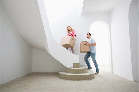 simsearch:693-07912629,k - Couple carrying cardboard boxes up stairs in new house Stock Photo - Premium Royalty-Free, Code: 693-07912573