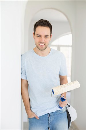 simsearch:693-07912629,k - Portrait of handsome man holding paint roller in new house Stock Photo - Premium Royalty-Free, Code: 693-07912581