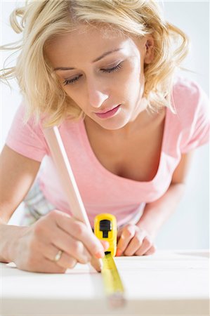 simsearch:693-07912629,k - Beautiful woman marking table with measure tape Stock Photo - Premium Royalty-Free, Code: 693-07912613