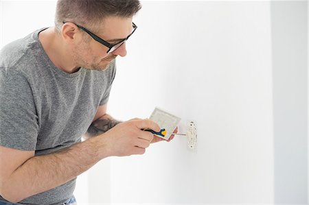 simsearch:693-07912629,k - Man working on electrical outlet Stock Photo - Premium Royalty-Free, Code: 693-07912653