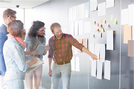 document - Young businessman explaining document to colleagues in creative office Stock Photo - Premium Royalty-Free, Code: 693-07913026