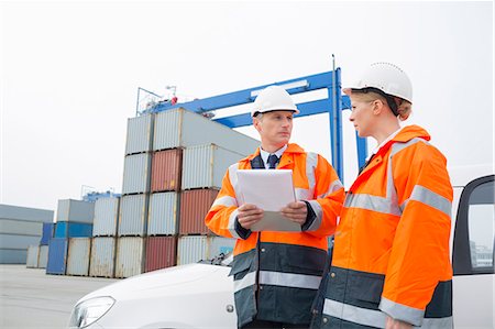 Workers conversing in shipping yard Stock Photo - Premium Royalty-Free, Code: 693-07913065