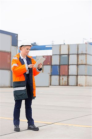 simsearch:693-07542313,k - Full-length of female engineer using tablet computer in shipping yard Stock Photo - Premium Royalty-Free, Code: 693-07913087