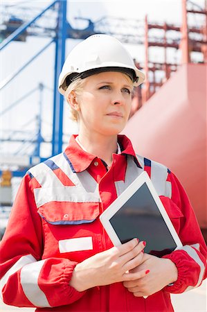 Female engineer holding tablet computer in shipping yard Stock Photo - Premium Royalty-Free, Code: 693-07913095