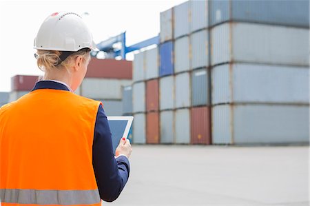 simsearch:693-07542313,k - Rear view of female engineer using digital tablet in shipping yard Stock Photo - Premium Royalty-Free, Code: 693-07913104