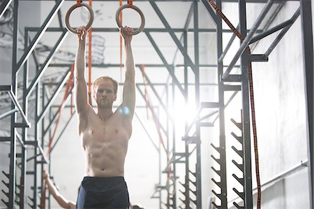 simsearch:693-08126938,k - Confident man exercising with gymnastic rings in crossfit gym Stock Photo - Premium Royalty-Free, Code: 693-08126918