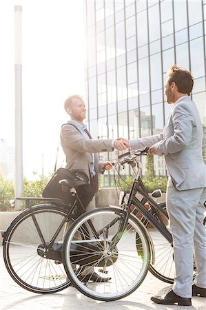 Businessmen shaking hands outside office building Stock Photo - Premium Royalty-Free, Code: 693-08127184