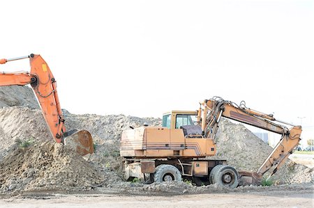 Bulldozers on construction site against clear sky Stock Photo - Premium Royalty-Free, Code: 693-08127732