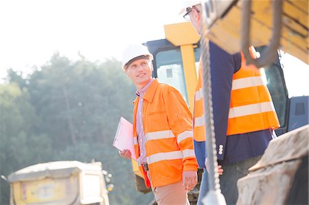 Supervisors discussing at construction site on sunny day Stock Photo - Premium Royalty-Free, Code: 693-08127748