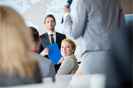 simsearch:846-05648290,k - Smiling businesswoman looking colleague speaking during seminar Stock Photo - Premium Royalty-Free, Code: 693-08769390